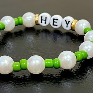 This is a handmade bracelet with green, white, and gold details 😊😊😊